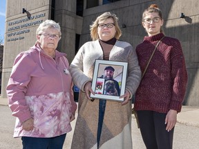Tracey Csordas (centre) holds a photo of her deceased brother Bryn Stoneman outside a Brantford courthouse on Thursday, March 7. With her is her mother Margaret Stoneman, and Tracey's daughter Karleigh Csordas.