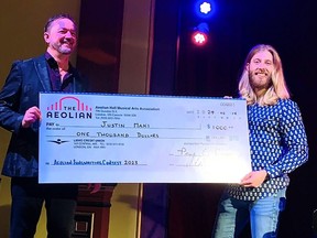 Justin Maki, right, accepts a $1,000 cheque from Aeolian Hall executive director Clark Bryan on Feb. 14 for winning second place in the Aeolian Hall national song writing contest for the song Tear Drops From A Phoenix, based on the life of Chatham resident Steve Bottrill. (Supplied photo)