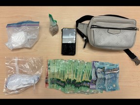 Cocaine, fentanyl, cash and a digital scale seized by the Kingston Police from an individual in the Rideau Heights neighbourhood in Kingston, Ont., on Thursday, March 14, 2024.
