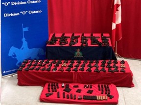 A photo from the RCMP shows 59 contraband firearms and 80 high-capacity magazines seized in a roadside stop on Nov. 26, 2021 near Cornwall.