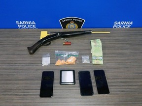 Sarnia police issued this photo of more than 76 grams of fentanyl, nearly three grams of cocaine, $120 in cash and a loaded single-barrel shotgun, after a raid on a Vimy Crescent home on Tuesday, Jan. 23, 2024. (Sarnia police)