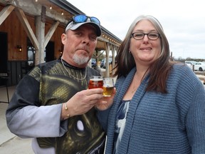 Trent and Kelly Lucas of St. Thomas raise sample glasses during a Cheers to the Coast event Saturday at Widder Station in Thedford.  The showcase for local craft beverage makers was organized by Tourism Sarnia-Lambton.