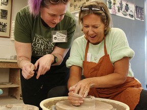 First-time Celebrity Bowl-a-Thon participant Ruth Drewitt, associate dean of quality assurance and international education at Lambton College, gets pointers from Sarnia Lambton Potters Guild member Ronni Blackmore as she makes a clay bowl.