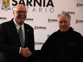 Associate Minister of Housing Rob Flack poses with Sarnia Mayor Mike Bradley at city hall during a $400,000 provincial building faster fund announcement for the city March 13, 2024.
