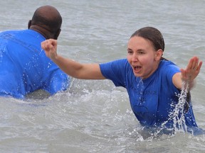 Tina Mel from Fairwinds Lodge reacts after jumping in Lake Huron Saturday during a Polar Bear Plunge at Canatara Park beach in Sarnia for St. Joseph's Hospice of Sarnia-Lambton. A total of $4,718 was raised by 11 participants.