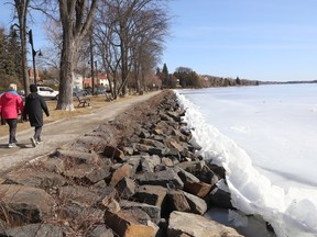 Ice pushes up against boulders on a shoreline at Ramsey Lake.