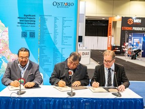 Marten Falls First Nation Chief Bruce Achneepineskum, from left, Webequie First Nation Chief Cornelius Wabasse, and Minister of Mines George Pirie sign an agreement at PDAC on Tuesday, March 5
