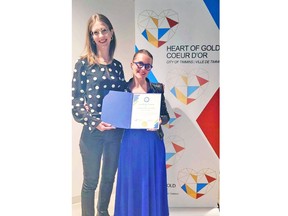 Timmins Mayor Michelle Boileau presents a Heart of Gold civic award to Stéphanie Morin-Robert on Friday, March 8 at the La Ronde Cultural Centre. The multidisciplinary artist had just performed her one-woman show "Blindside" at the centre. SUPPLIED/CITY OF TIMMINS