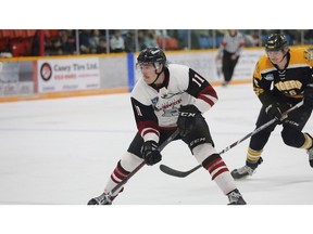 Ludovic Dufort (11) of the Miramichi Timberwolves is pursued by Austin Arsenault (16) of the Campbellton Tigers.