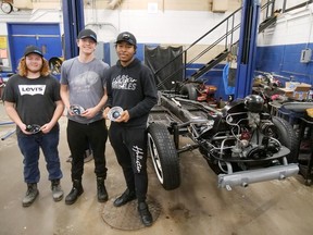Simcoe Composite School transportation students, from left, Noah Mahoney, Alex Samborski and Bryan Wallace stand next to the 1956 Volkswagen Beetle restored by Grade 10 and Grade 12 students last semester at SCS. It's a 'work in progress' and is expected to be completed in the 2024-25 school year. CHRIS ABBOTT