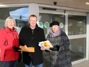 Elaine Gunderson, left, and Lynne Connell, right, presented a petition calling for "complete replacement" of the Whitecourt hospital to MLA Martin Long, outside the Whitecourt Healthcare Centre in 2022. This week, Long said the 2024-27 capital plan under the 2024 Alberta budget includes funds for hospital planning in Whitecourt.