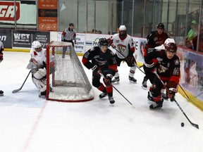Dylan Leslie, right, backed by Whitecourt Wolverines teammate Jarred Feist, took the puck behind the Camrose Kodiaks' net during first round of playoffs. The Wolverines emerged triumphant and will take on the Canmore Eagles in the second round, starting 7 p.m. on March 29 at JDA Place.