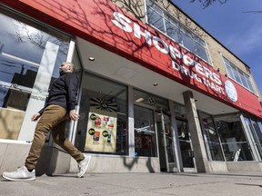 A potential customer walked by a Shoppers Drug Mart in Toronto