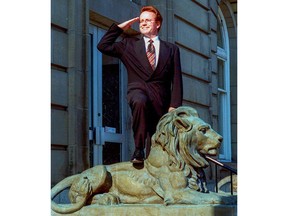 Actor and comedian Phil Hartman stands on a lion statue at the Federal Building in Brantford during a visit to the city in 1997.