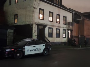 A Saint John police car is seen outside the Charles Street apartment where officers say Justin Breau was killed Aug. 17, 2022.