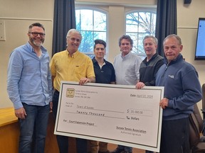 Corey McAllister of Brown's Paving, Sussex Tennis Association vce-president Kirk Sabine, club manager Mike Wood, board member Ron Soper and president Ted Robertson hand a fundraising cheque for $20,000 to Sussex Mayor Marc Thorne, third from right