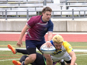 Brantford Collegiate Institute's Sam Cavan lunges for a try against Assumption College on Tuesday during AABHN senior boys rugby action at Bisons Alumni North Park Sports Complex. Brian Smiley