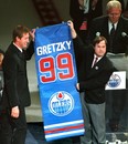 Oct. 1, 1999. The greatest Edmonton Oilers and National Hockey League's (NHL) player of all times, Wayne Gretzky, with the help of his long-time and close friend Edmonton Oilers locker room attendant Joey Moss hold up Gretzky's mini-replica version of the banner at #99 number retirement and banner raising night on Oct. 1, 1999 at the Skyreach Centre in Edmonton, Alta. In the background (right) is the master of ceremonies, long-time and NHL Hall of Fame announcer Rod Phillips. Perry Mah/Edmonton Sun/QMI Agency