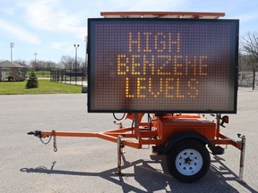 A portable electronic sign in the parking lot of the Aamjiwnaang First Nation offices on Tashmoo Avenue near Sarnia warns of high benzene levels in the air on Friday, April 26, 2024. (Paul Morden/The Observer)