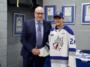 Sudbury Wolves general manager Rob Papineau, left, poses for a photo with 2024 second-round draft pick Ethan Dean.