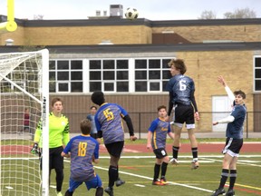 Players from Assumption College and Brantford Collegiate Institute watch as an ACS cross misses its intended target on Monday during an AABHN boys soccer game at Kiwanis Field. Brian Smiley