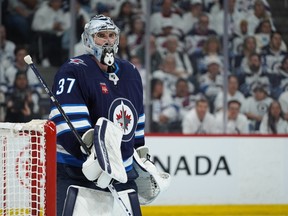 Connor Hellebuyck of Winnipeg Jets looks on during action against the Colorado Avalanche.