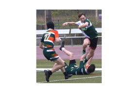 Ryley Boake of St. John’s College steps over a North Park Collegiate defender on his way to scoring a try during an AABHN senior boys rugby game at Kiwanis Field on Tuesday. Brian Smiley