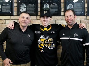 Sarnia Sting first-round draft pick Alessandro Di Iorio is welcomed by general manager Dylan Seca, left, and director of hockey operations David Legwand, right, at a news conference at Progressive Auto Sales Arena in Sarnia, Ont., on Saturday, April 13, 2024. (Mark MalonePostmedia Network)
