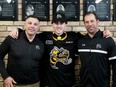 Sarnia Sting first-round draft pick Alessandro Di Iorio is welcomed by general manager Dylan Seca, left, and director of hockey operations David Legwand, right, at a news conference at Progressive Auto Sales Arena in Sarnia, Ont., on Saturday, April 13, 2024. Mark Malone/Chatham Daily News/Postmedia Network