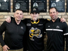 Sarnia Sting first-round draft pick Alessandro Di Iorio is welcomed by general manager Dylan Seca, left, and director of hockey operations David Legwand, right, at a news conference at Progressive Auto Sales Arena in Sarnia, Ont., on Saturday, April 13, 2024. Mark Malone/Chatham Daily News/Postmedia Network