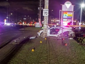 A White Audi in shambles after an alleged race with another car on April 4 on Dixie Road led to it hittting a hydro pole and two occupants, who were not wearing seatbelts, dying.