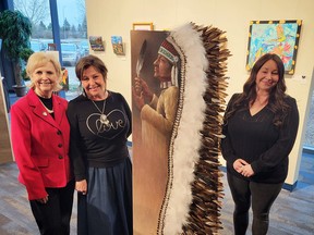 Mayor Katchur, Ellie Lagrandeur and Stacey Shearing pose with the Art in Public Places piece.