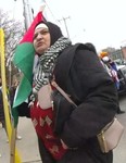 Maryam Alnazer, 61, of Mississauga has been charged with five offences after it's alleged she hit a police horse with a flagpole during a March 30 protest at Gerrard Street East and Parliament Street in Toronto.