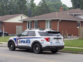 A police vehicle is parked in front of a home on Admiral Drive in London as police investigate the discovery of stolen vehicles on Tuesday, June 27, 2023. (Derek Ruttan/London Free Press)
