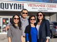 Tan Pham and his wife Du Bui are flanked by their daughters Quynh Nguyen, left, and Nhi Phan, right, outside the family's Quynh Nhi restaurant at 55 Wharncliffe Rd. North in London on Monday, April 15, 2024. The couple is closing the restaurant April 27 to spend more time with family. (Derek Ruttan/The London Free Press)