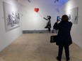 Gabriela Sterescu said that while living in her home country, Romania, she felt Banksy's work "expresses a freedom, makes a statement, shows us what is happening." She checked out the exhibit, The Art of Banksy: Without Limits, in downtown London on April 18, 2024. (Mike Hensen/The London Free Press)