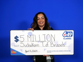 Terpstra stands with a giant cheque.