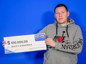 Brent Staats, age 39 of Brantford holds a cheque for $100,000 from OLF after an Encore win in the February 9, 2024 Lotto Max draw.