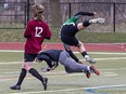 Evan Wilson of the St. John's Eagles collides with Pauline Johnson Thunderbirds goalkeeper Greyson Vandewal during an AABHN high school boys soccer game on Wednesday April 24, 2024 at Kiwanis Field in Brantford, Ontario. Brian Thompson/Brantford Expositor/Postmedia Network