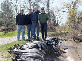 The popular marsh trail is filled again with birders, hikers and cyclists, along with duck hunters, thanks to the an effort spearheaded by the Rondeau Bay Waterfowlers' Association. The achievement was celebrated Monday to mark Earth Day. Seen here from left, near part of the trail that was rehabilitated, is Ed Myslik, RBWA president, Mark Braet with the Ontario Federation of Anglers and Hunters, Peter Leistra, RBWA treasurer and RBWA public relations person Dean McBrayne. PHOTO Ellwood Shreve