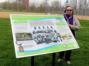 Lisa Gilbert displays a plaque, showcasing the history of the Chatham Coloured All-Stars baseball team, located at Stirling Park in Chatham where the team played their home games. The plaque is one of several created by the Chatham-Kent Heritage Network with more to be unveiled in the coming weeks. (Ellwood Shreve/Chatham Daily News)