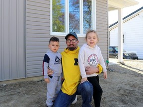 Adam Ferren and his children, Maize, 4, left, and Adalynn, 6, are excited to be moving into their new home in Chatham, which is one-half of a multi-unit home built by Habitat for Humanity Chatham-Kent. (Ellwood Shreve/ Daily News)