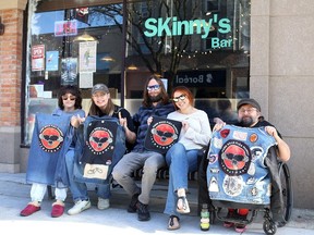 Chatham Punk Rock Flea Market organizers Emma Reaume and Lilian Gungner, left, and Adam Kearney, flank Aaron Sparks and Nadia Owen, owners of downtown Chatham's Skinny's Bar, at 162 King St. W., which is hosting two market events on May 11 and 31. (Ellwood Shreve/Chatham Daily News)
