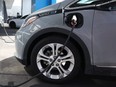 A Chevrolet Bolt electric vehicle sits parked at a charging station in Colma, Calif., April 25, 2023.