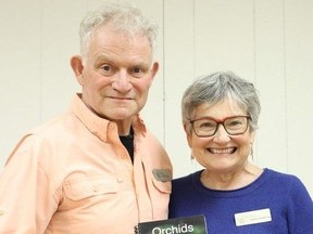 Willy Waterton and Audrey Armstrong, authors and photographer of the updated guide to Orchids: Bruce & Grey, pose with the book following the Huron Fringe Field Naturalists meeting in April. Christine Roberts photo