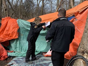City of Kingston Bylaw Enforcement officers at the Belle Park encampment enforcing the day time ban on camping in Kingston, Ont., on Tuesday, April 2, 2024.