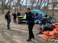 City of Kingston Bylaw Enforcement officers at the Belle Park encampment enforcing the day time ban on camping in Kingston, Ont., on Tuesday, April 2, 2024. (Elliot Ferguson/The Whig-Standard/Postmedia Network)
