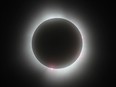 The moon eclipses the sun during the total solar eclipse in Kingston