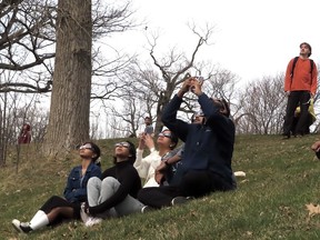 People watch the total eclipse in Kingston's Lake Ontario Park