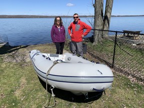 Janet and Ken Reid stand next to the dinghy they used to rescue a pair of canoeists on the Rideau Canal Sunday